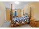 This charming bedroom features a decorative four-poster bed and matching wooden furniture at 2930 S Semoran Blvd # 408, Orlando, FL 32822