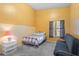 The bedroom is brightly lit and features a futon, side table, and large window at 2930 S Semoran Blvd # 408, Orlando, FL 32822