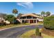 Welcoming clubhouse with modern design, large windows, mature landscaping, and convenient circular driveway at 2930 S Semoran Blvd # 408, Orlando, FL 32822
