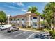 Well-maintained condo building with dedicated parking and landscaped surroundings at 2930 S Semoran Blvd # 408, Orlando, FL 32822