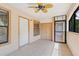 Cozy screened patio with tile flooring, ceiling fan, and secure entry door at 2930 S Semoran Blvd # 408, Orlando, FL 32822
