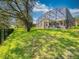 Beautiful backyard featuring green grass, trees and a screened in pool with covered patio at 3216 Rolling Hills Ln, Apopka, FL 32712