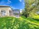 Expansive backyard with lush lawn, mature trees, fenced perimeter and screened in pool at 3216 Rolling Hills Ln, Apopka, FL 32712