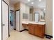 Spacious bathroom featuring a large mirror, ample vanity space, and tile flooring at 3216 Rolling Hills Ln, Apopka, FL 32712