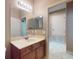 Bathroom featuring a vanity with wood cabinets, a mirror, and tile flooring at 3216 Rolling Hills Ln, Apopka, FL 32712