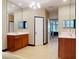 Well-lit bathroom with double sinks, large mirrors, and neutral tile flooring at 3216 Rolling Hills Ln, Apopka, FL 32712