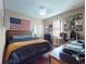 Cozy bedroom with American flag, desk, and unique wall decor at 3216 Rolling Hills Ln, Apopka, FL 32712