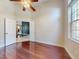 Bedroom featuring hardwood floors, ceiling fan, and open entry at 3216 Rolling Hills Ln, Apopka, FL 32712