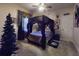 Themed bedroom with a four-poster canopy bed, ambient lighting, and gothic decor at 3216 Rolling Hills Ln, Apopka, FL 32712