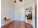 Bedroom with hardwood floors, ceiling fan, and entry to dining area at 3216 Rolling Hills Ln, Apopka, FL 32712