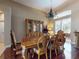 Dining room features a dark wood dining table, six upholstered chairs, and a decorative wooden china cabinet at 3216 Rolling Hills Ln, Apopka, FL 32712