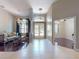 Elegant foyer features a combination of tile and wood flooring, chandelier lighting, and a view of the living room at 3216 Rolling Hills Ln, Apopka, FL 32712