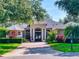 Charming single-story home featuring a brick driveway, well-manicured landscaping, and elegant architectural details at 3216 Rolling Hills Ln, Apopka, FL 32712