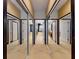 Hallway featuring carpeted floors, mirrors, and white doors at 3216 Rolling Hills Ln, Apopka, FL 32712