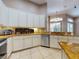Bright kitchen features stainless steel appliances, granite countertops, tile floors, and white cabinets at 3216 Rolling Hills Ln, Apopka, FL 32712