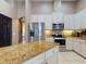 Kitchen boasts stainless appliances, granite countertops, white cabinets and a breakfast bar at 3216 Rolling Hills Ln, Apopka, FL 32712