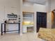 Kitchen with a granite countertop breakfast bar, a wine rack, and a desk with a dark door at 3216 Rolling Hills Ln, Apopka, FL 32712