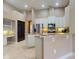 Kitchen with a granite breakfast bar, white cabinets, stainless steel appliances, and tile floors at 3216 Rolling Hills Ln, Apopka, FL 32712