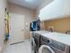 Functional laundry room with washer, dryer, and ample storage space at 3216 Rolling Hills Ln, Apopka, FL 32712