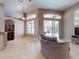 Open living room with tile flooring, view of pool, and ample lighting at 3216 Rolling Hills Ln, Apopka, FL 32712