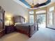 Large main bedroom features tray ceilings, a ceiling fan, and large glass doors to the porch at 3216 Rolling Hills Ln, Apopka, FL 32712