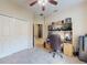 Functional office space with neutral carpet, ceiling fan, closet, and desk area, providing a comfortable work environment at 3216 Rolling Hills Ln, Apopka, FL 32712