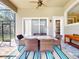 Relaxing outdoor dining area on the lanai with a view of the serene and private backyard at 3216 Rolling Hills Ln, Apopka, FL 32712