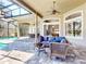 Relaxing poolside view with a seamless transition from the outdoor patio featuring a seating and dining area at 3216 Rolling Hills Ln, Apopka, FL 32712