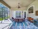 Charming outdoor dining area on the covered patio, with neutral tones and a view of the landscaped backyard at 3216 Rolling Hills Ln, Apopka, FL 32712