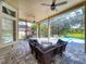 Expansive screened-in lanai offers views of a sparkling pool, a cozy seating area, and a shaded swing at 3216 Rolling Hills Ln, Apopka, FL 32712