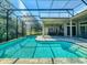 Beautiful screened-in pool with stone surround and adjacent outdoor patio with dining set at 3216 Rolling Hills Ln, Apopka, FL 32712