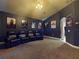 Home theater featuring reclining seats, movie posters, and dimmable lights at 3216 Rolling Hills Ln, Apopka, FL 32712