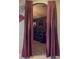 View of the theater room entrance with elegant red curtains and movie posters at 3216 Rolling Hills Ln, Apopka, FL 32712
