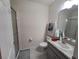 Neat bathroom with a shower, vanity, granite countertop, sink, and chrome hardware at 3316 Bellissimo Ave, Kissimmee, FL 34746