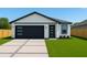 Charming single-story home featuring modern design elements, neutral stucco, dark trim, and a well-manicured lawn at 3325 W Washington St, Orlando, FL 32805