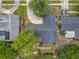 Aerial view of a home's roof, driveway, landscaping, and neighboring homes on a sunny day at 3443 Arnel Dr, Winter Park, FL 32792