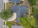 Birds eye view of a home's roof, driveway, landscaping, and neighborhood streets on a sunny day at 3443 Arnel Dr, Winter Park, FL 32792