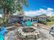 The backyard features a fire pit and adjacent sunroom perfect for outdoor living and relaxation at 3443 Arnel Dr, Winter Park, FL 32792