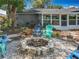 This backyard features a fire pit, sunroom and Adirondack chairs, offering a perfect spot for outdoor relaxation at 3443 Arnel Dr, Winter Park, FL 32792