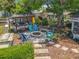 Inviting backyard with a fire pit, outdoor seating, and charming patio area under mature trees at 3443 Arnel Dr, Winter Park, FL 32792