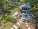 Aerial view of backyard featuring a fire pit, outdoor kitchen, play set, and lush landscaping at 3443 Arnel Dr, Winter Park, FL 32792