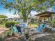 Backyard oasis featuring a fire pit and outdoor kitchen, providing a perfect space for relaxation and outdoor cooking at 3443 Arnel Dr, Winter Park, FL 32792