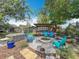 Inviting backyard featuring a fire pit, outdoor kitchen, and lush landscaping, perfect for entertaining at 3443 Arnel Dr, Winter Park, FL 32792