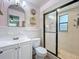 Clean bathroom featuring white tile, a glass-enclosed shower, and modern fixtures at 3443 Arnel Dr, Winter Park, FL 32792
