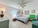 Cozy bedroom with pink walls, wood floors, a ceiling fan, and bright natural light at 3443 Arnel Dr, Winter Park, FL 32792