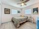 Well-lit bedroom with a ceiling fan, wood floors, and bright natural light from two windows at 3443 Arnel Dr, Winter Park, FL 32792
