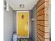 Charming entryway with a bright yellow door and unique address detail with a decorative stool at 3443 Arnel Dr, Winter Park, FL 32792