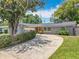 Charming one-story home with a winding driveway, mature landscaping, and an attached garage at 3443 Arnel Dr, Winter Park, FL 32792