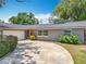 Attractive home with a lush lawn, mature landscaping, and an attached garage at 3443 Arnel Dr, Winter Park, FL 32792