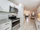 Modern kitchen featuring stainless steel appliances, granite countertops, and white cabinets at 3443 Arnel Dr, Winter Park, FL 32792